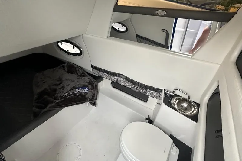 Slide: The Image of Interior of 2025 Nor-Tech 340 Sport Center Console with bed and compact bathroom. - 31