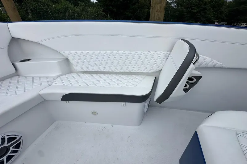 Slide: The Image of 2025 Nor-Tech 340 Sport Center Console interior with white seating and speaker detail. - 33