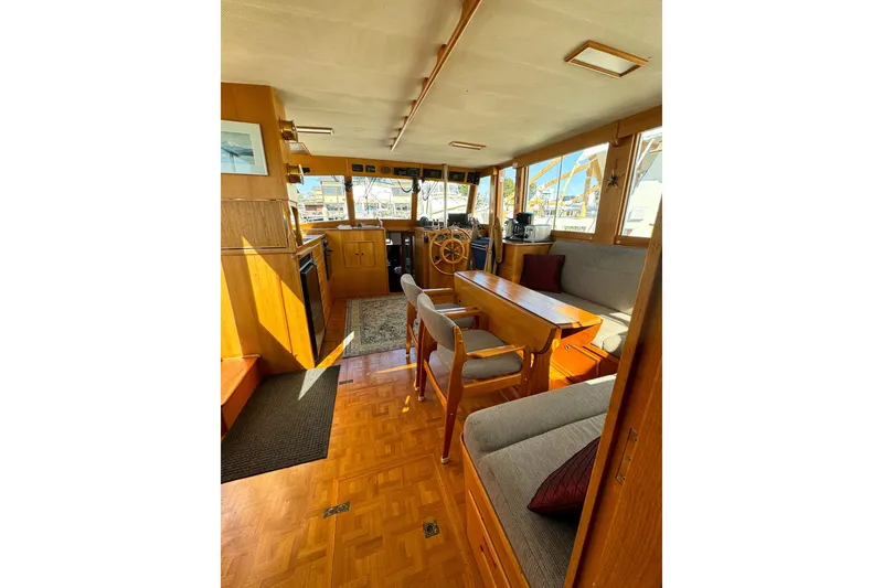 Slide: The Image of Interior of 1990 Grand Banks Classic yacht with wooden furnishings and helm station. - 11