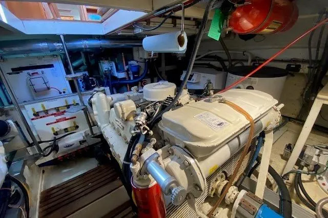 Slide: The Image of Engine room of a 1990 Grand Banks Classic boat, showcasing mechanical components and equipment. - 16