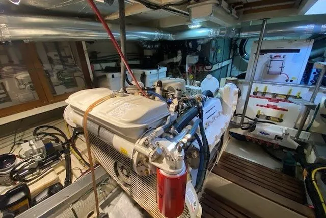 Slide: The Image of Engine room of a 1990 Grand Banks Classic yacht, showcasing mechanical components and equipment. - 18