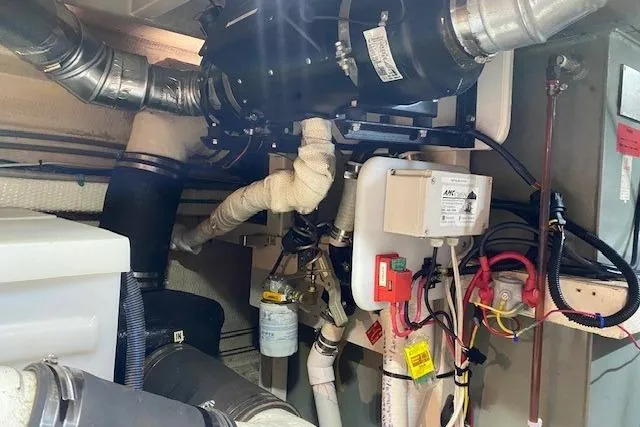 Slide: The Image of Engine room of 1990 Grand Banks Classic boat with visible pipes and machinery. - 20