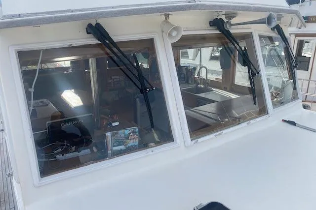 Slide: The Image of 1990 Grand Banks Classic boat cockpit with windshield wipers and interior view. - 21