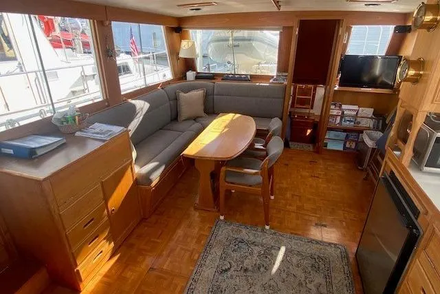 Slide: The Image of Interior of 1990 Grand Banks Classic yacht with cozy seating and wooden furnishings. - 8