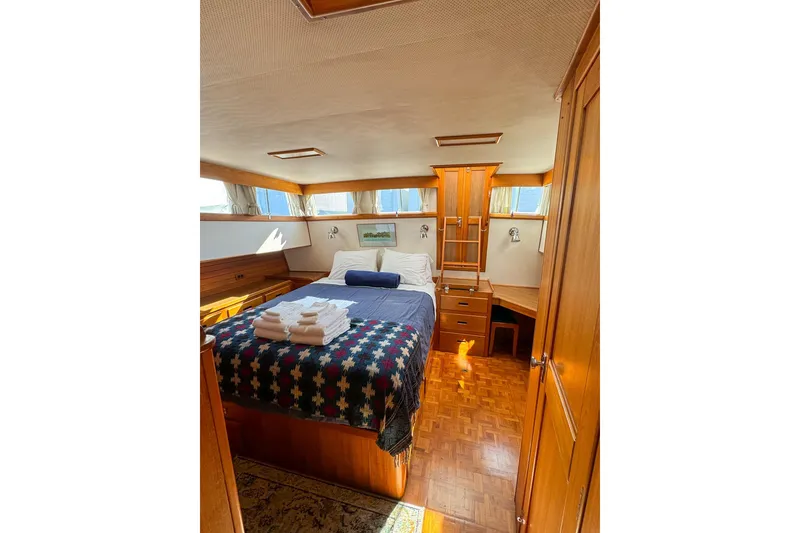 Slide: The Image of Cozy bedroom in 1990 Grand Banks Classic yacht with wood accents and natural light. - 9