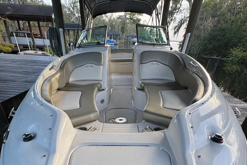 Slide: The Image of 2005 Sea Ray 240 Sundeck boat interior with cushioned seating and open deck. - 14