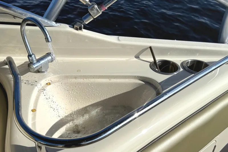 Slide: The Image of 2005 Sea Ray 240 Sundeck boat sink with running water and cup holders. - 17