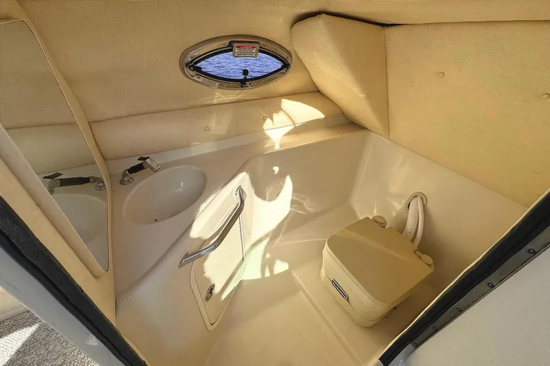 Slide: The Image of 2005 Sea Ray 240 Sundeck interior with sink and portable toilet. - 19