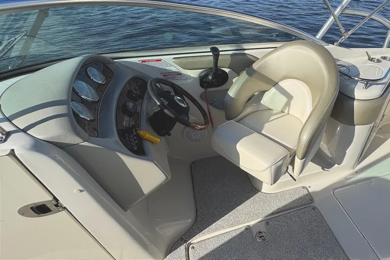 Slide: The Image of 2005 Sea Ray 240 Sundeck boat interior with steering wheel and seating. - 21