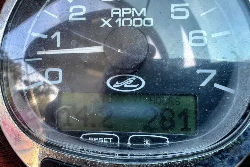 Slide: The Image of Close-up of a 2005 Sea Ray 240 Sundeck RPM gauge displaying engine hours. - 22