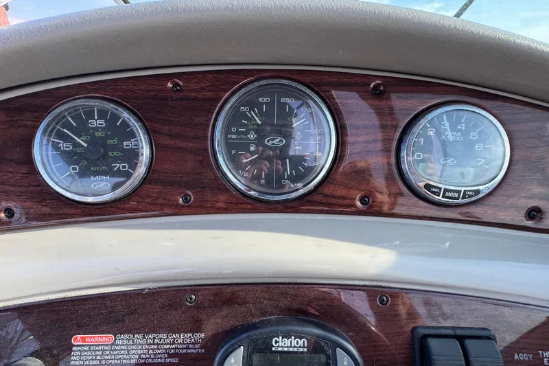 Slide: The Image of Dashboard of a 2005 Sea Ray 240 Sundeck boat with speedometer and gauges. - 24