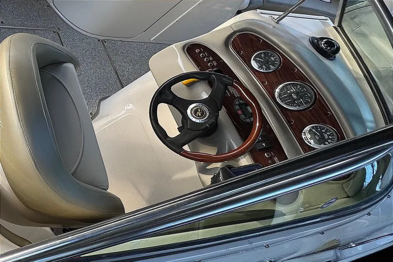 Slide: The Image of 2005 Sea Ray 240 Sundeck dashboard with steering wheel and instrument panel. - 27