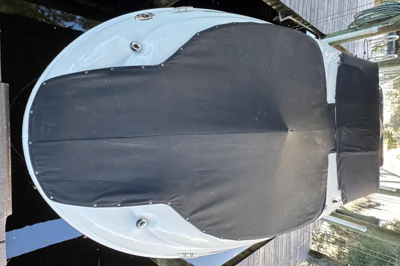 Slide: The Image of 2005 Sea Ray 240 Sundeck boat with black cover docked at marina. - 44