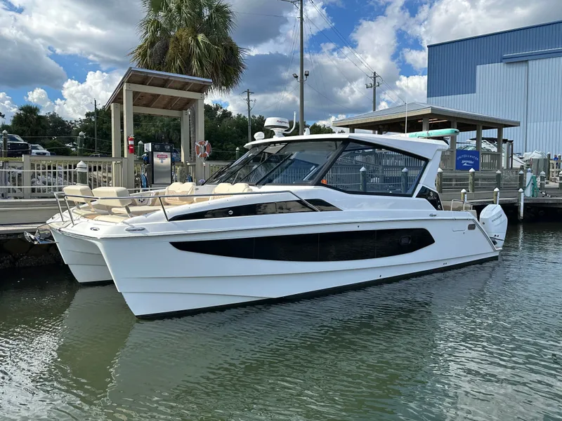 Slide: The Image of 2025 Aquila 36 Sport boat docked at marina under blue sky. - 0
