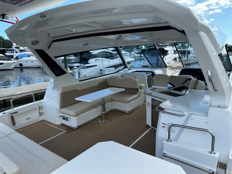 Slide: The Image of 2025 Aquila 36 Sport yacht interior with seating and table, docked at marina. - 10