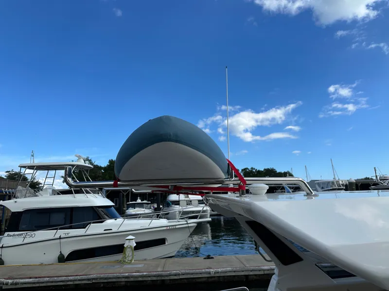 Slide: The Image of 2025 Aquila 36 Sport yacht docked at marina under clear blue sky. - 12