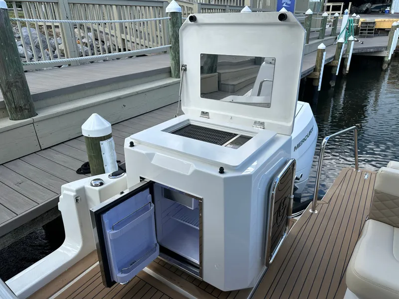 Slide: The Image of Aquila 36 Sport 2025 boat with open fridge and grill on deck. - 16