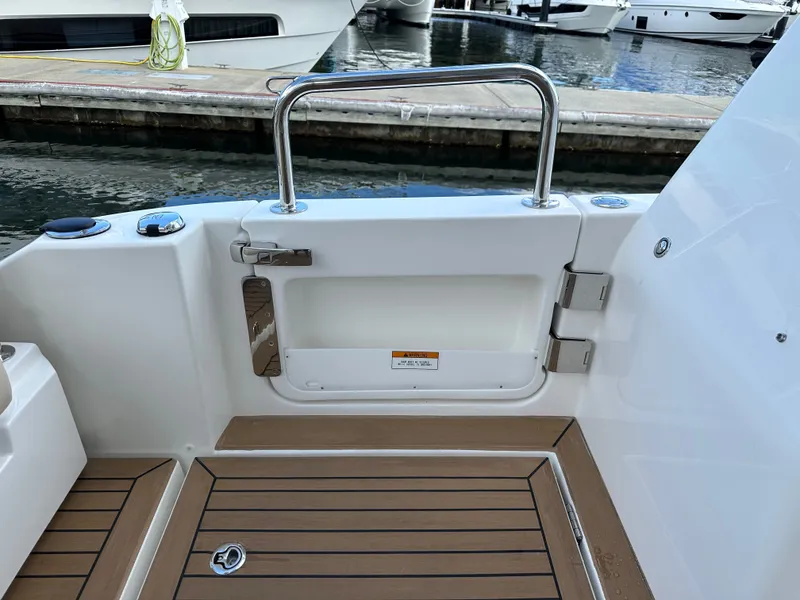 Slide: The Image of Aquila 36 Sport 2025 boat deck with teak flooring and stainless steel railing. - 18