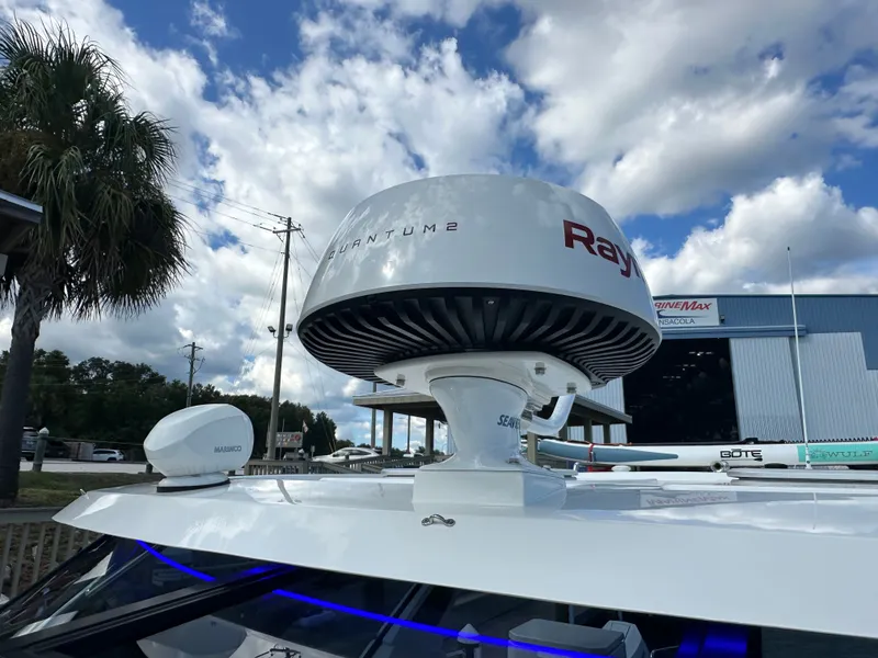 Slide: The Image of Radar equipment on 2025 Aquila 36 Sport boat under a partly cloudy sky. - 23