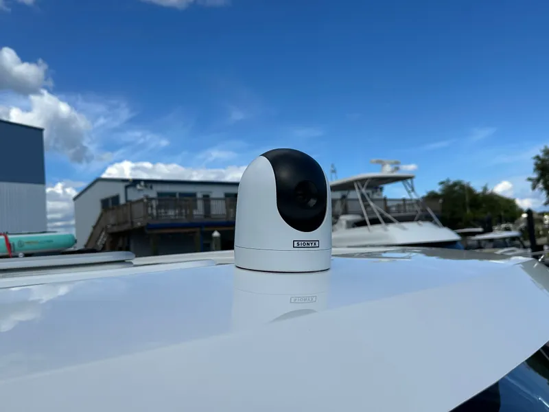 Slide: The Image of Camera mounted on 2025 Aquila 36 Sport boat under clear blue sky. - 24