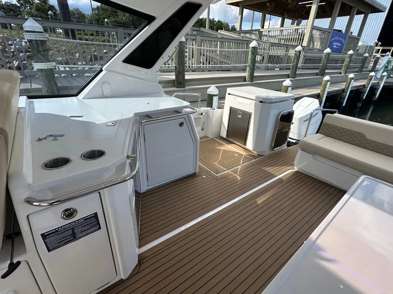 Slide: The Image of Aquila 36 Sport 2025 boat interior with sleek seating and modern amenities at a dock. - 29