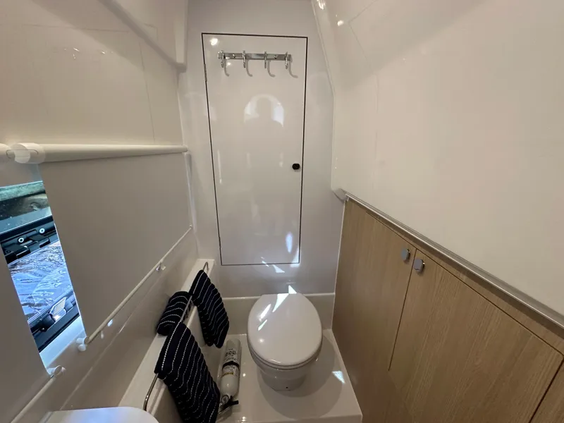 Slide: The Image of 2025 Aquila 36 Sport bathroom interior with modern fixtures and wooden cabinetry. - 34