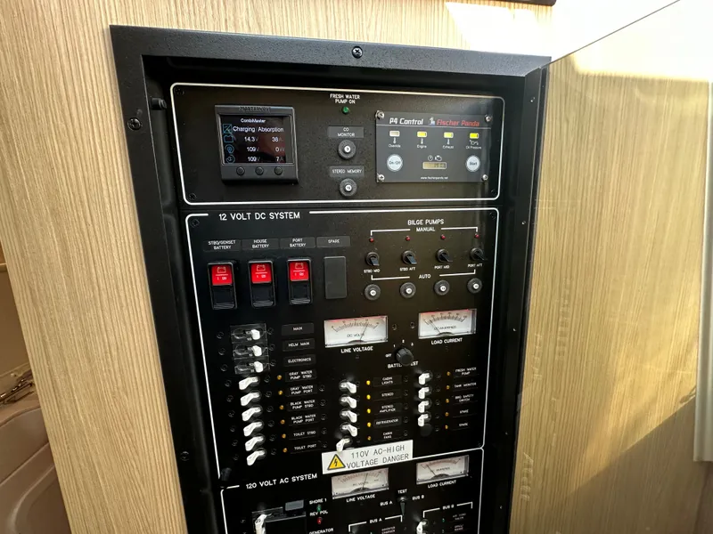 Slide: The Image of Control panel of 2025 Aquila 36 Sport boat, featuring electrical and bilge pump systems. - 36