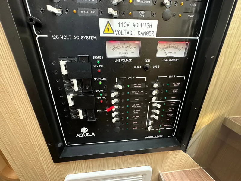 Slide: The Image of Electrical control panel of 2025 Aquila 36 Sport boat, featuring 120V AC system. - 37