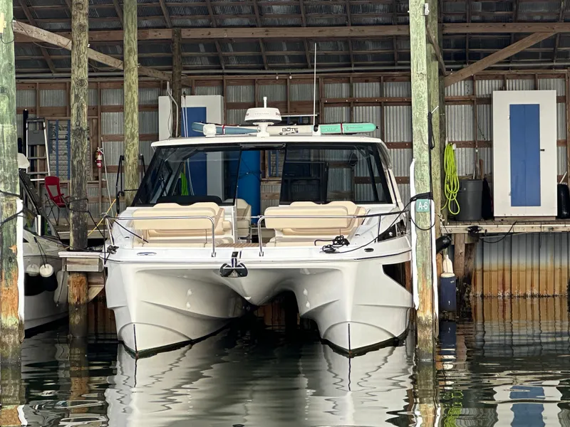 Slide: The Image of 2025 Aquila 36 Sport boat docked in a covered marina. - 38