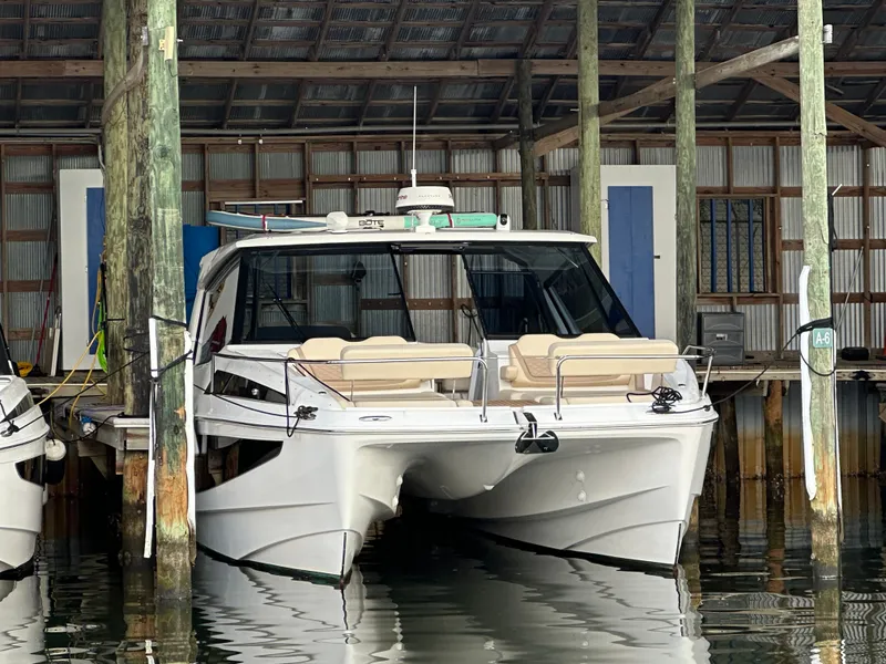 Slide: The Image of 2025 Aquila 36 Sport boat docked in a marina, front view. - 39