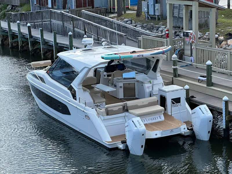 Slide: The Image of 2025 Aquila 36 Sport boat docked, featuring sleek design and modern amenities. - 7