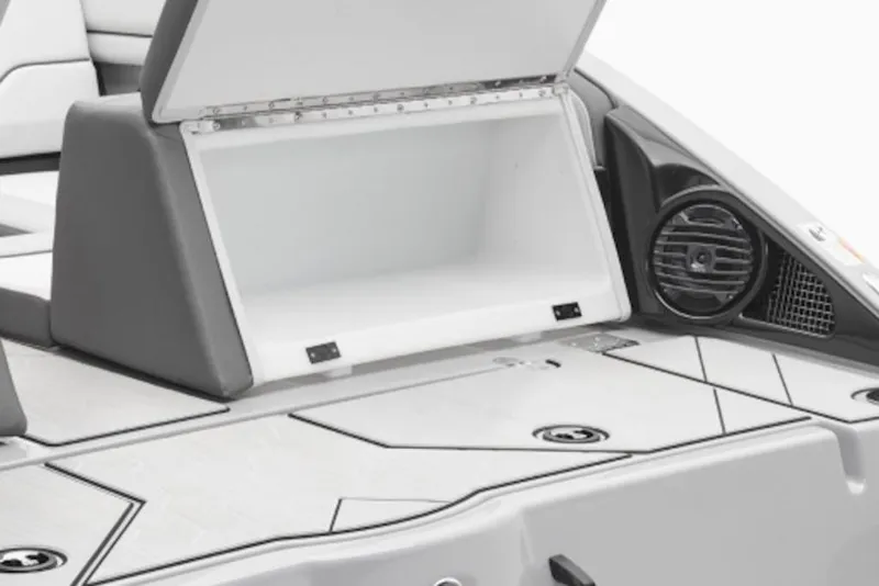 Slide: The Image of Open storage compartment on 2026 Yamaha Boats 252XE with speaker detail. - 6