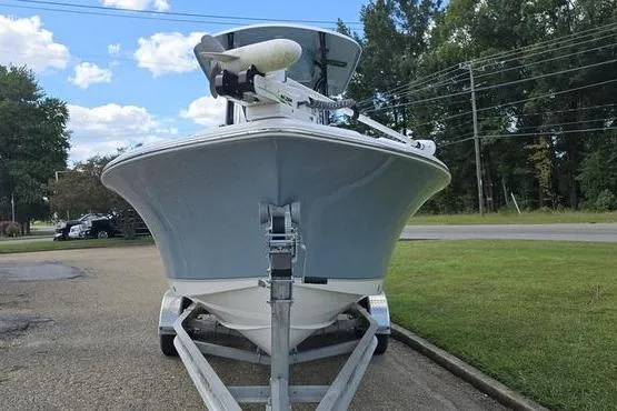 The Image of 2023 Sea Hunt Ultra 234 boat on trailer, parked outdoors, under a partly cloudy sky. - 1
