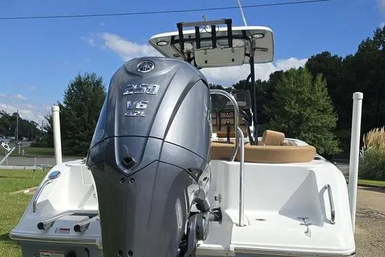 Slide: The Image of 2023 Sea Hunt Ultra 234 boat with tan cushioned seating and white deck. - 8