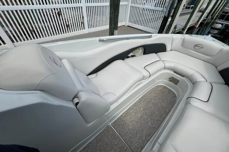 Slide: The Image of 2015 Crownline 285 SS boat interior with white leather seating and carpeted flooring. - 16
