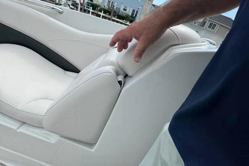 Slide: The Image of 2015 Crownline 285 SS boat seat with hand adjusting headrest. - 18