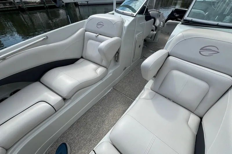 Slide: The Image of 2015 Crownline 285 SS boat interior with luxurious white seating and sleek design. - 19