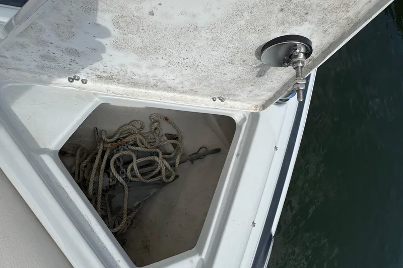 Slide: The Image of Open anchor compartment on 2015 Crownline 285 SS boat with ropes inside. - 22