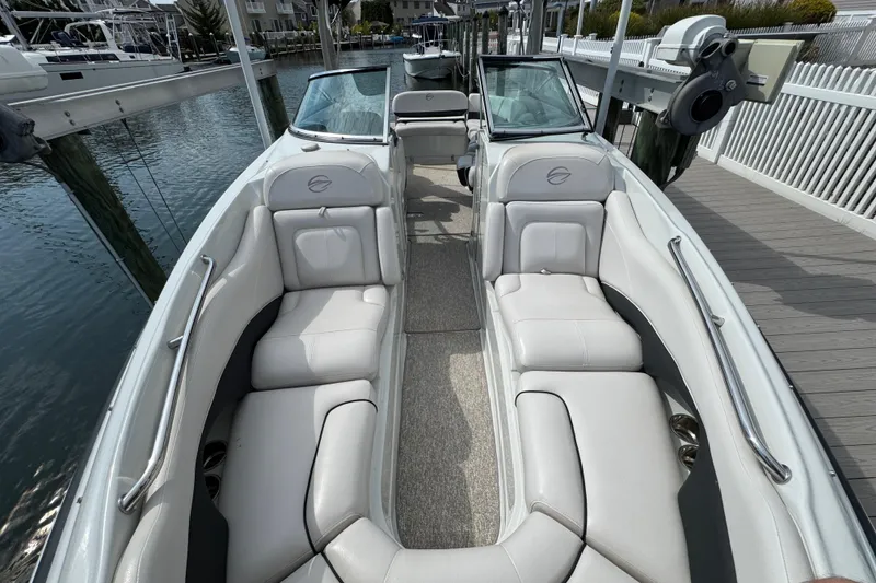 Slide: The Image of 2015 Crownline 285 SS boat with spacious seating, docked by the water. - 27