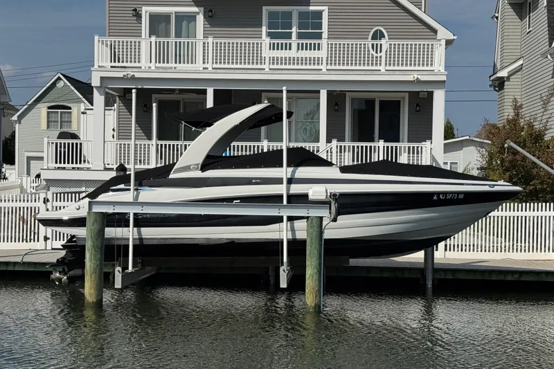 The Image of 2015 Crownline 285 SS boat docked near waterfront house. - 3