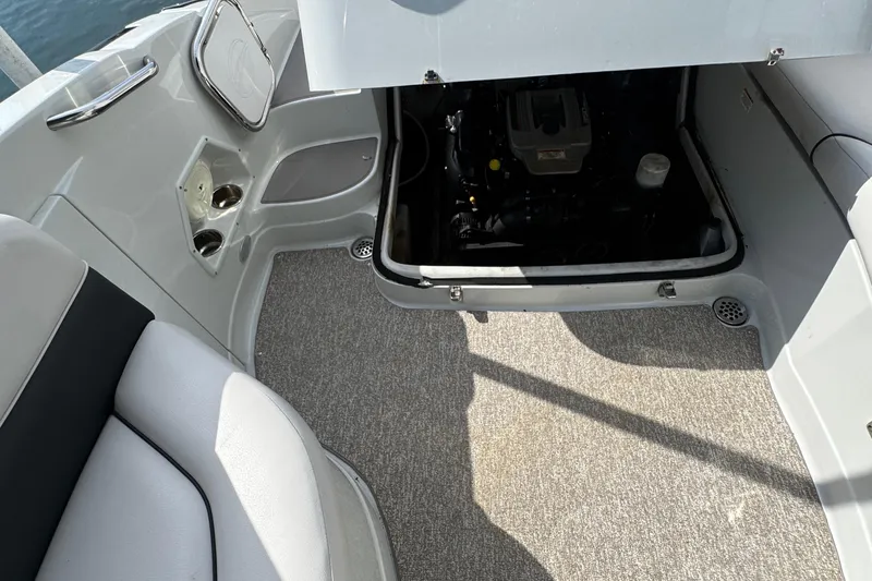 Slide: The Image of 2015 Crownline 285 SS boat interior with open engine compartment and seating area. - 36