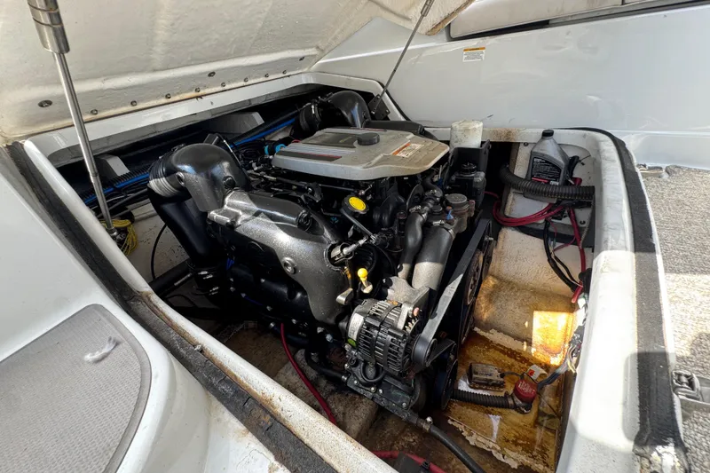 Slide: The Image of Engine compartment of a 2015 Crownline 285 SS boat, showcasing detailed mechanics. - 38