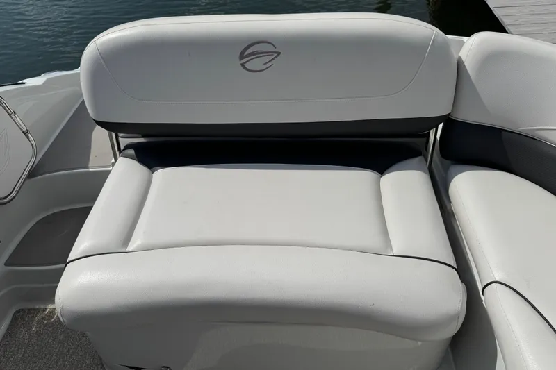 Slide: The Image of 2015 Crownline 285 SS boat seat with logo, featuring white upholstery and sleek design. - 42