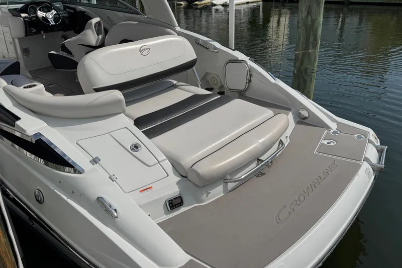 Slide: The Image of 2015 Crownline 285 SS boat with sleek seating and modern design on the water. - 47
