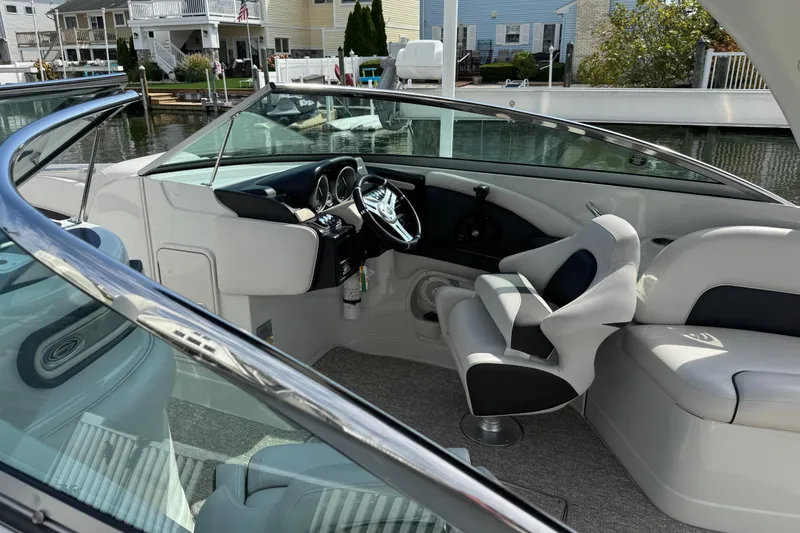 Slide: The Image of Interior of a 2015 Crownline 285 SS boat with sleek seating and modern dashboard. - 50