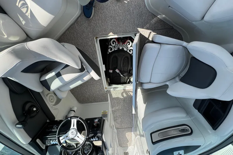 Slide: The Image of 2015 Crownline 285 SS boat interior with seating and storage compartment. - 62
