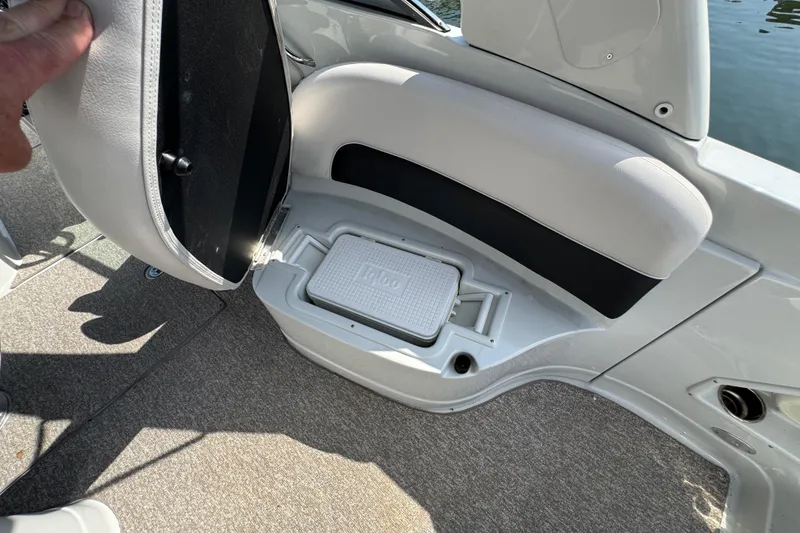 Slide: The Image of 2015 Crownline 285 SS boat interior with storage compartment and Igloo cooler. - 63