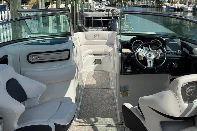 Slide: The Image of Interior of a 2015 Crownline 285 SS boat with steering wheel and seating. - 69