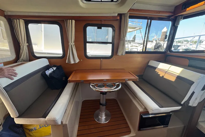 Slide: The Image of Interior of 2016 Ranger Tugs R-25SC with dining area and windows. - 10