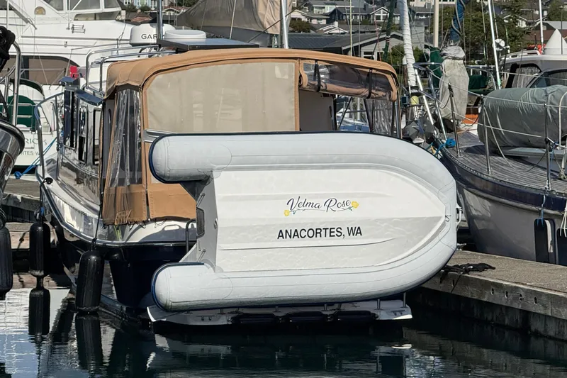 Slide: The Image of 2016 Ranger Tugs R-25SC docked in Anacortes, WA, with inflatable boat attached. - 27